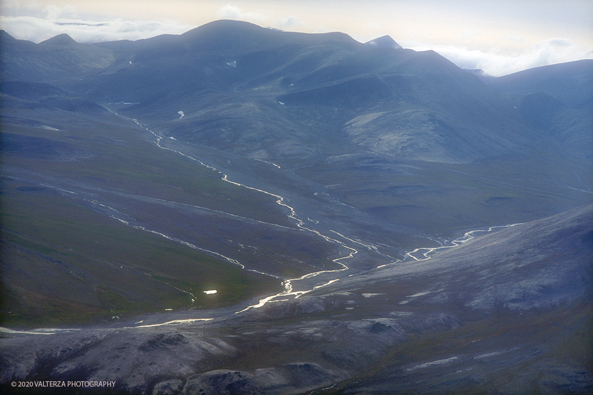 89 SIBERIA.jpg - Luglio/Agosto 1992. Siberia, terra dei Chukchi. Nell'oceano artico  125 Km a nord-est della penisola dei Chukchi (Siberia) c'Ã¨ l'isola di Wrangel, essa ospita piÃ¹ del doppio di specie vegetali (417) di qualsiasi territorio artico a paritÃ  di superficie nonchÃ¨ 30 specie diverse di uccelli oltre ad orsi polari, foche e trichechi ; per questo motivo   Ã¨ stata proclamata patrimonio dell'umanitÃ  dall'UNESCO. Nella foto i rilievi montuosi della parte cetntro su dell'isolala cui cima piÃ¹ alta Ã¨ il monte G. Sowjetskaja di 1096 m.